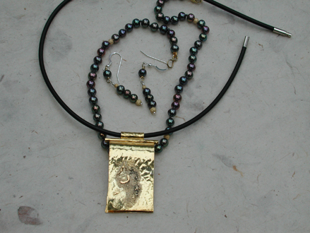 FOLDED - removable necklace over freshwater pearls, matching eardrops, neoprene circle.